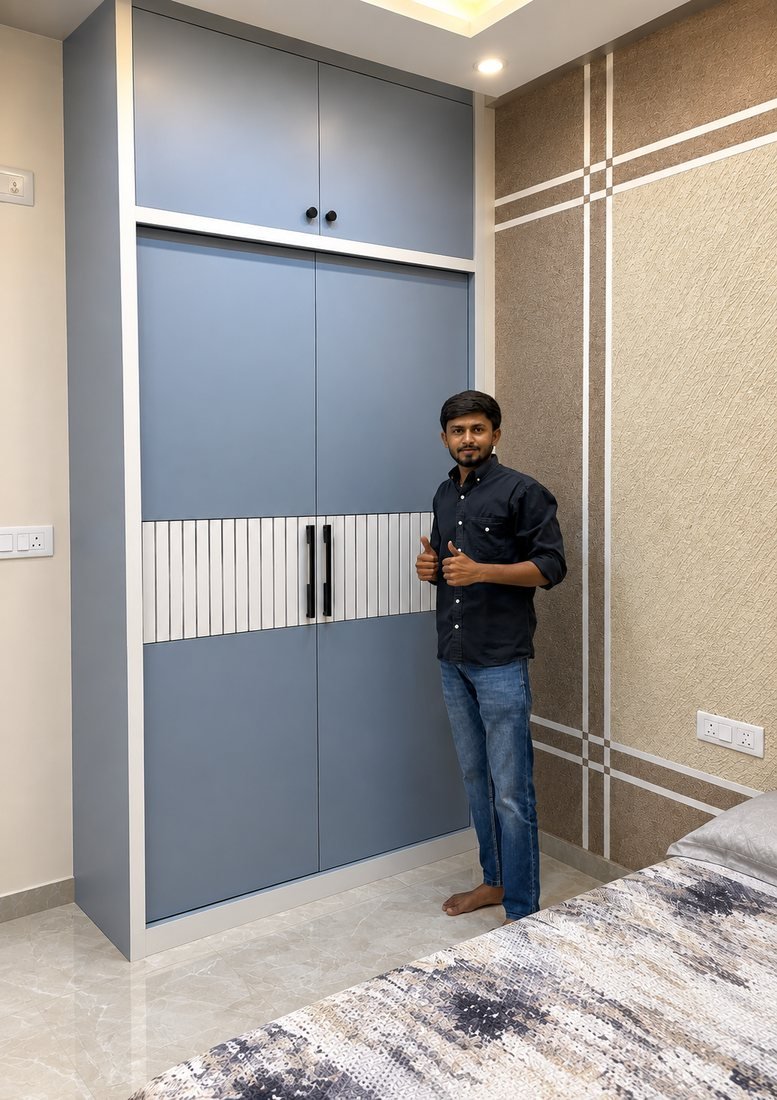 Pradeep Kumar, owner of Shree Maruthi Furnitures, beside a wardrobe he built
