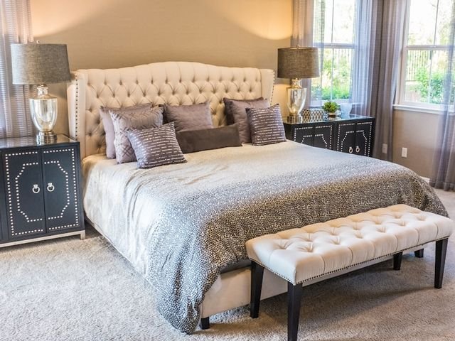Bedroom with a tufted upholstered bed