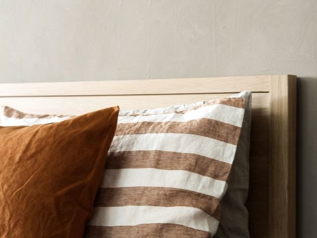 Solid wood bed headboard with linen bedding