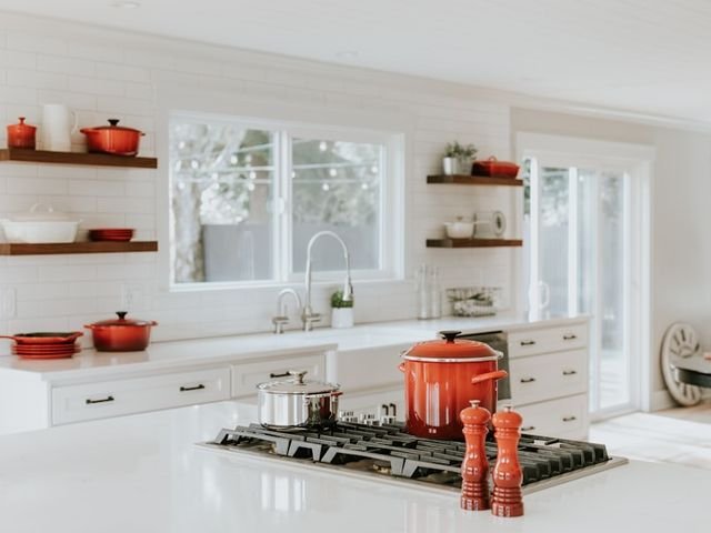 White kitchen cabinets with open wooden shelves