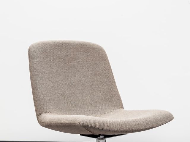Beige upholstered swivel lounge chair
