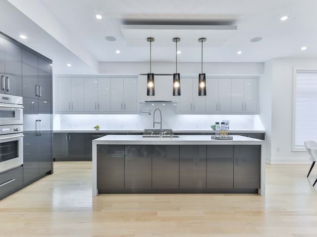 Modular kitchen with island and glossy cabinets