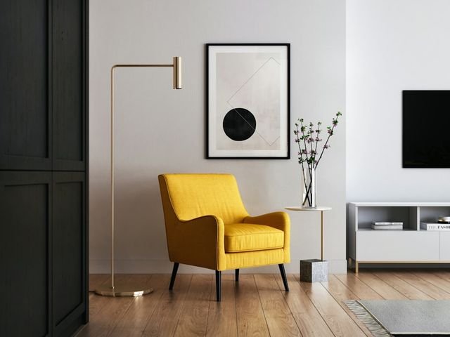 Yellow armchair beside a small round side table