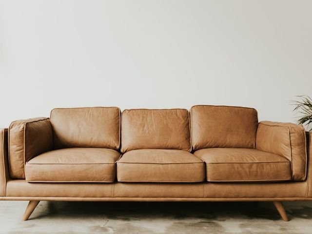 Tan leather three seater sofa