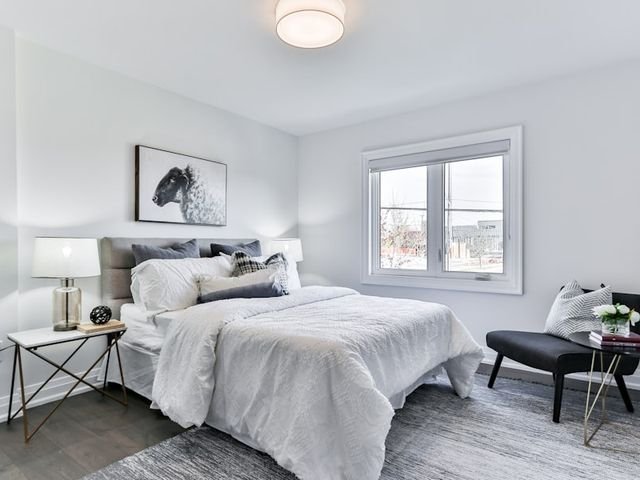 Grey upholstered bed in a bright bedroom