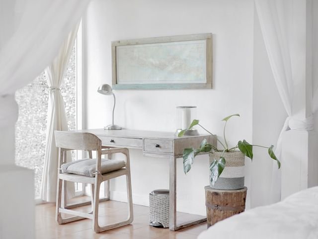 Wooden writing desk with drawers and a chair