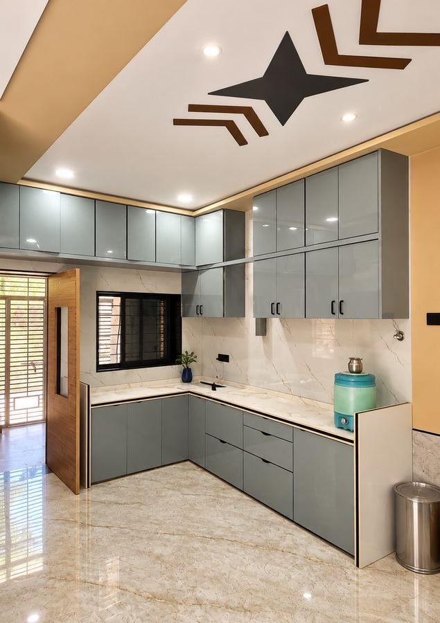 L-shaped modular kitchen with glossy grey shutters and marble counter